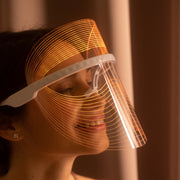 Magic Glow 7in1 LED BeautyShield 
Woman enjoying a hands-free LED light therapy session with the Magic Glow 7-in-1 BeautyShield mask by GYM IN A BOX®; luxury skin treatment at home and on the go .
