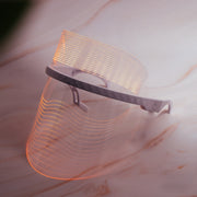 Magic Glow 7-in-1 LED BeautyShield by GYM IN A BOX® – premium light therapy face mask featuring 7 clinically-targeted LED wavelengths for anti-aging, acne treatment, skin brightening, and wrinkle reduction. Lightweight, hands-free, USB rechargeable, and designed with transparent NASA-inspired technology for at-home professional skincare