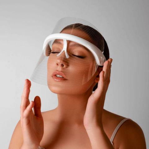 Magic Glow 7in1 LED BeautyShield 
Woman enjoying a hands-free LED light therapy session with the Magic Glow 7-in-1 BeautyShield mask by GYM IN A BOX®; luxury skin treatment at home and on the go .