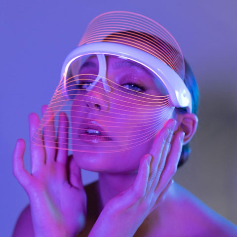 Magic Glow 7in1 LED BeautyShield 
Woman enjoying a hands-free LED light therapy session with the Magic Glow 7-in-1 BeautyShield mask by GYM IN A BOX®; luxury skin treatment at home and on the go .