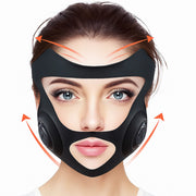 Luxury black facelift mask worn by woman for jawline and cheek lift using GYM IN A BOX® patented ToneUp15® StimFit Beauty Technology. Metallic pink, gold, and black branding. Hands-free wearable for sculpting face in 15 minutes.