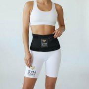 Person wearing a black waist trainer with 'Gym in a Box' branding on a plain background