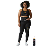 Woman wearing boss lady deluxe bundle GYM IN A BOX StimFitBelt black and gym in a box StimFitBelt powerpants athletic wear with visible branding, standing next to the fit & firm gel by Nika on the griund. White background 